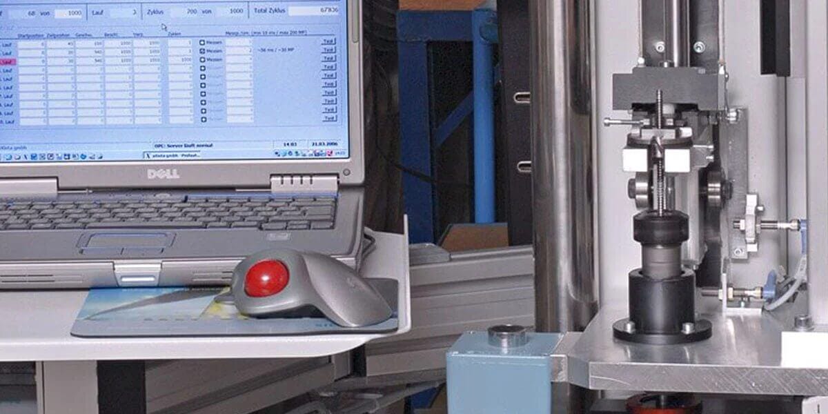 Laptop next to testing machine in the lab