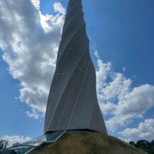 Spiral tower against blue sky and clouds.