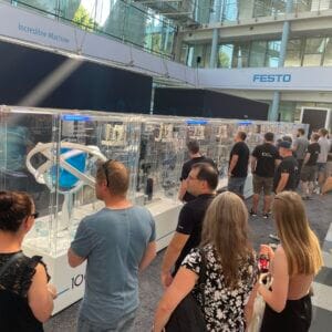 People looking at machines at a Festo exhibition.